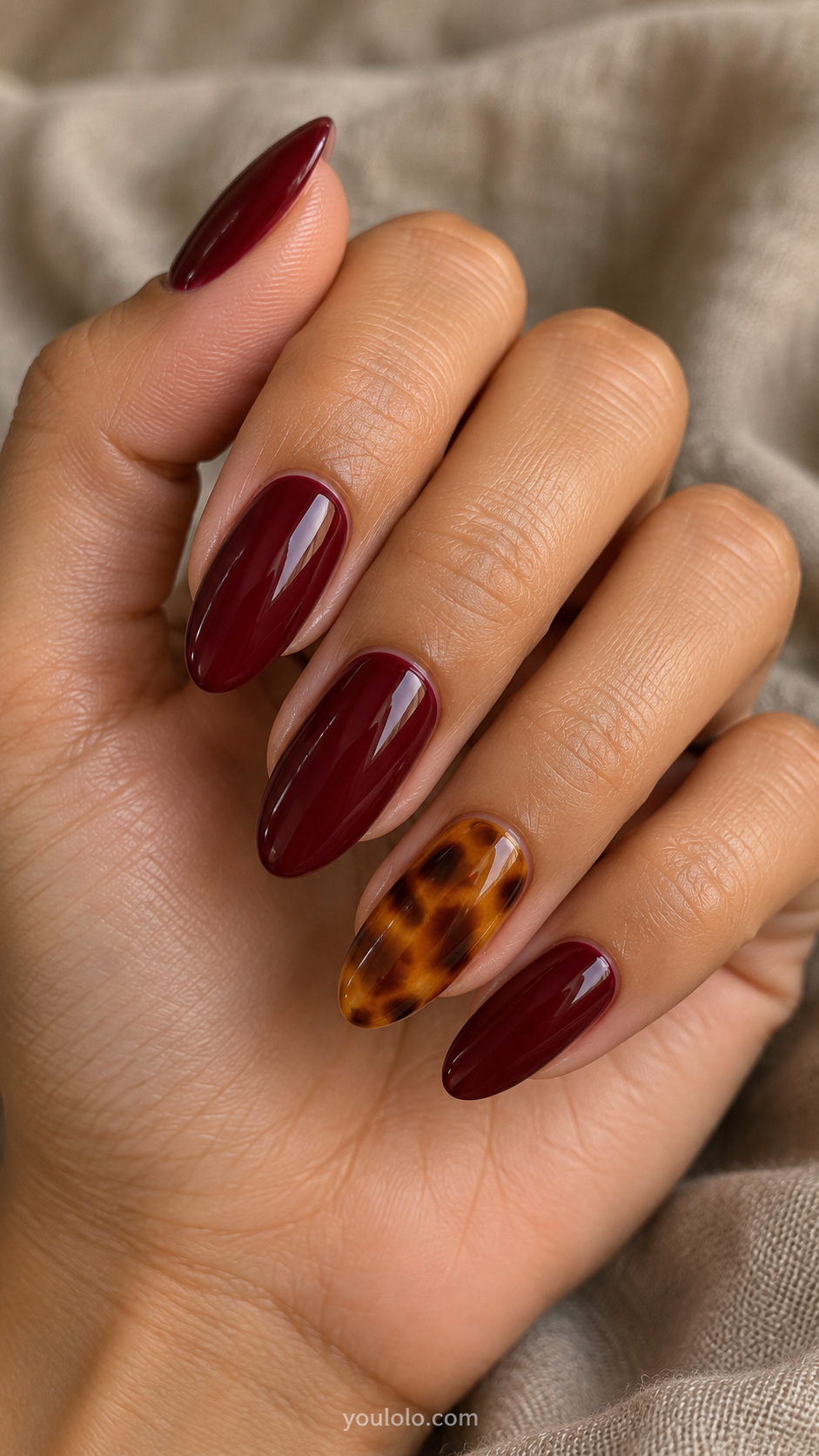Tortoiseshell nails — burgundy with one amber accent
