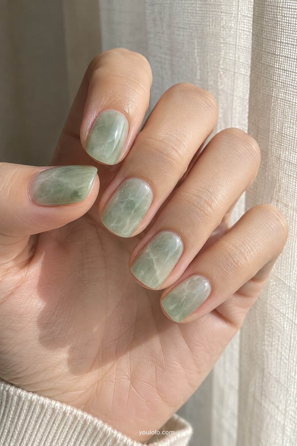 Pale celadon marble manicure with delicate natural veining