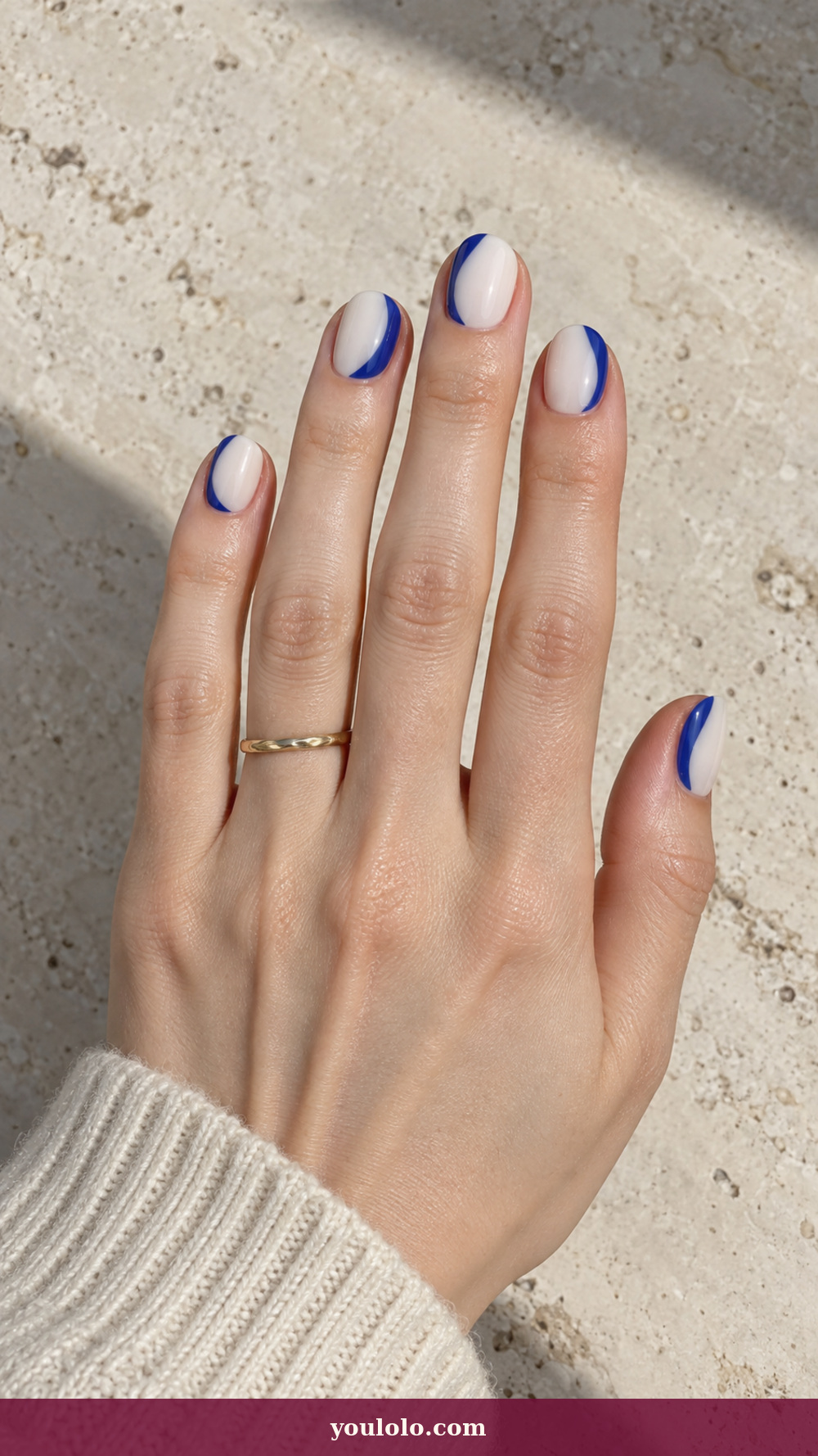 Blue and White Nails idea 1: Cobalt Brush Crescents on a realistic feminine hand