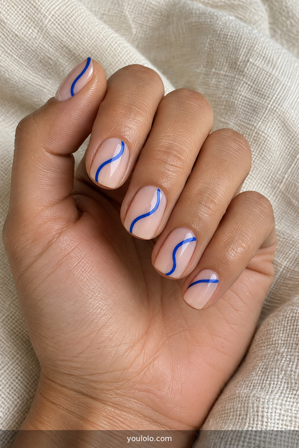 Creative Nails with cobalt blue negative-space curves on short nails