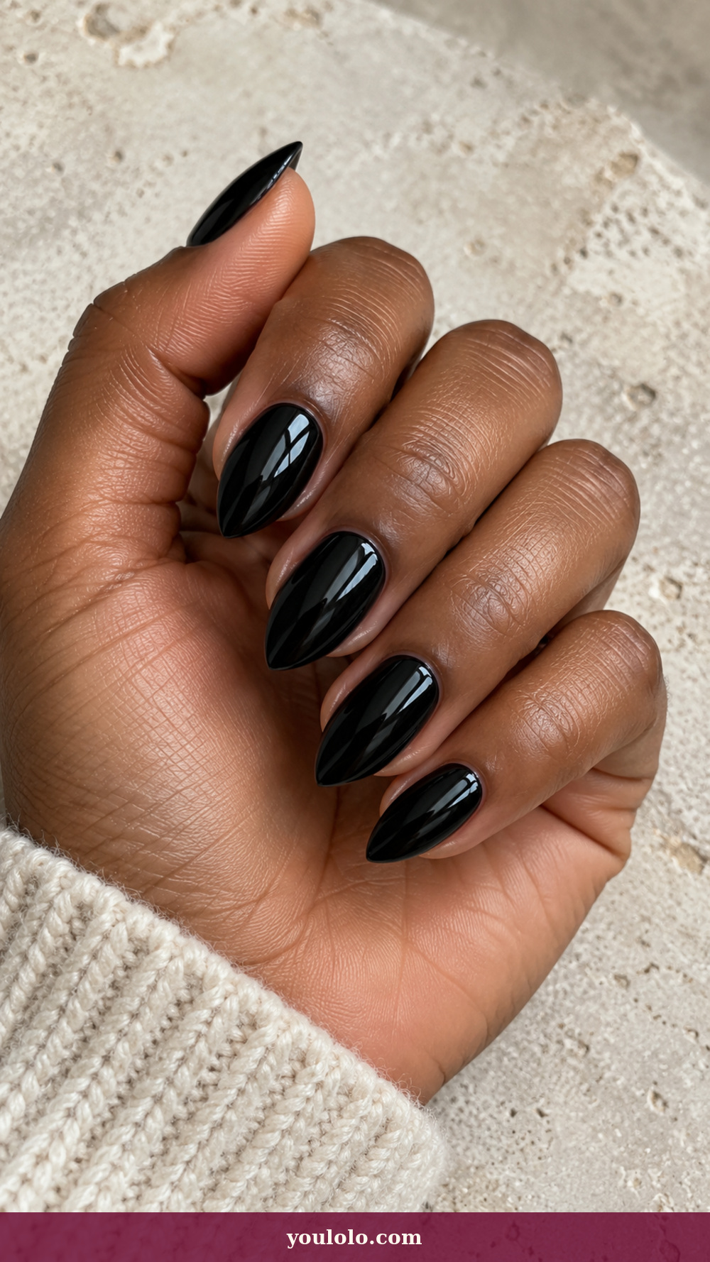 Short Stiletto Nails idea 1: Ink Black Lacquer Points on a realistic feminine hand