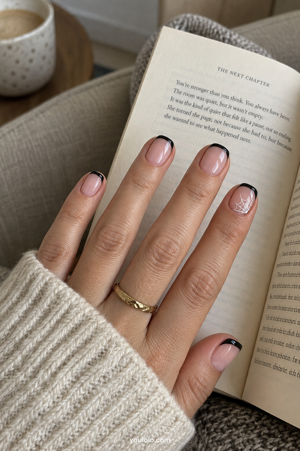 Black micro French manicure with one delicate spiderweb accent