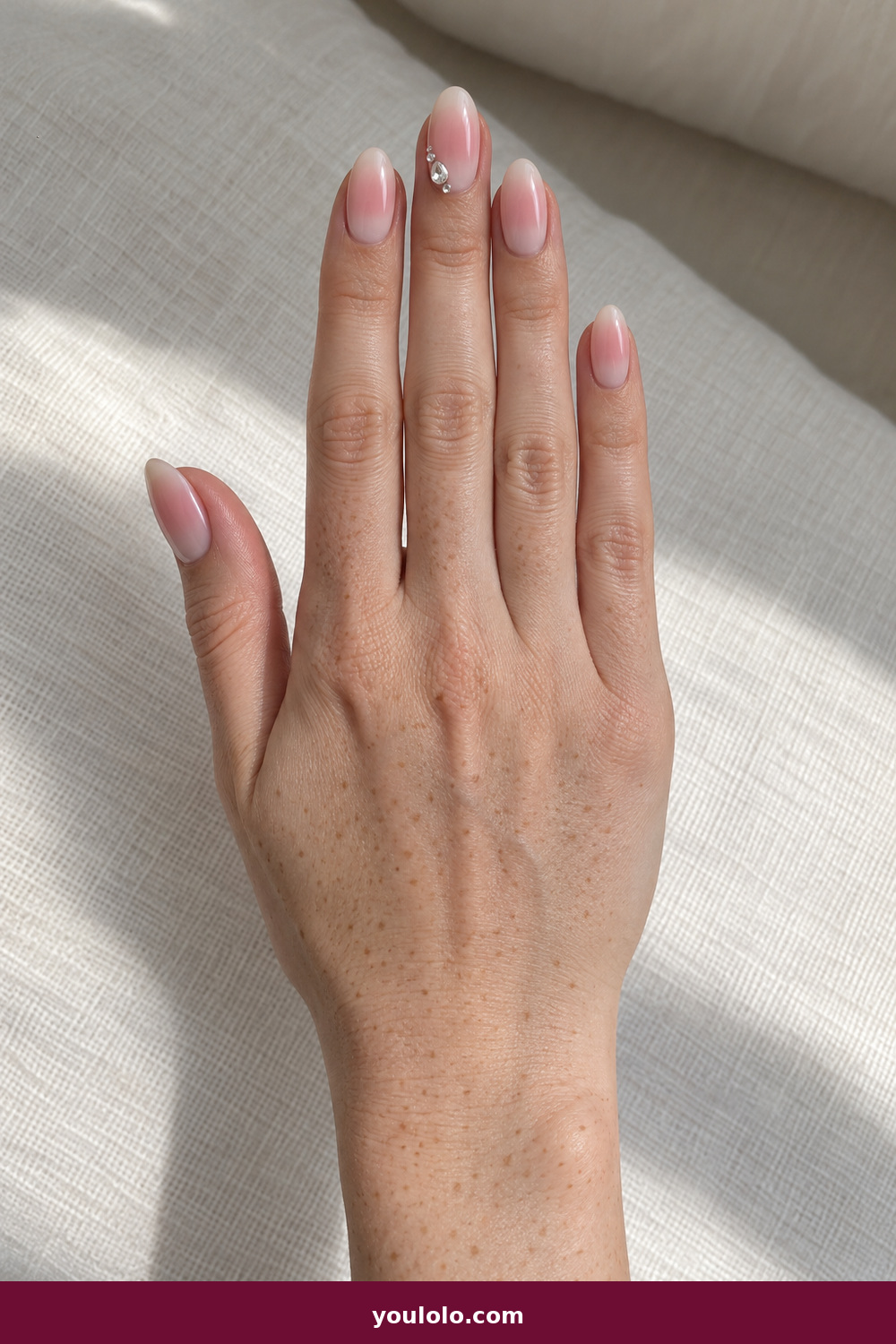 Pink Nails with Rhinestones on One Finger Ideas: Blush Aura Jewel Cluster, Milky oval nails with diffused blush aura centers and one asymmetric pear-and-micro-crystal cluster on the middle finger.