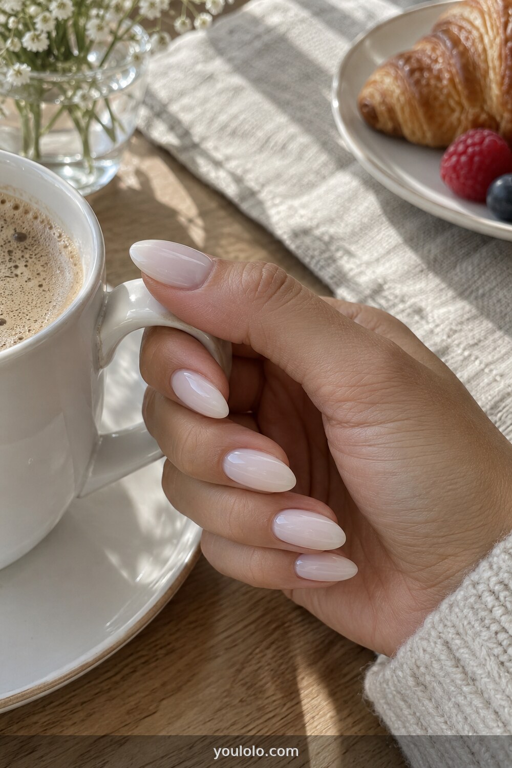 Milky white almond manicure in a natural lifestyle photo