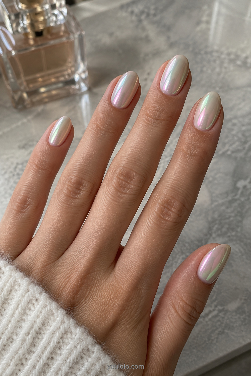 White opal chrome Unicorn Nails on a classic oval shape