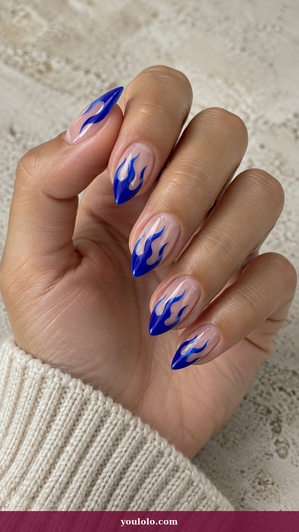 Short Stiletto Nails idea 3: Cobalt Flame Tips on a realistic feminine hand