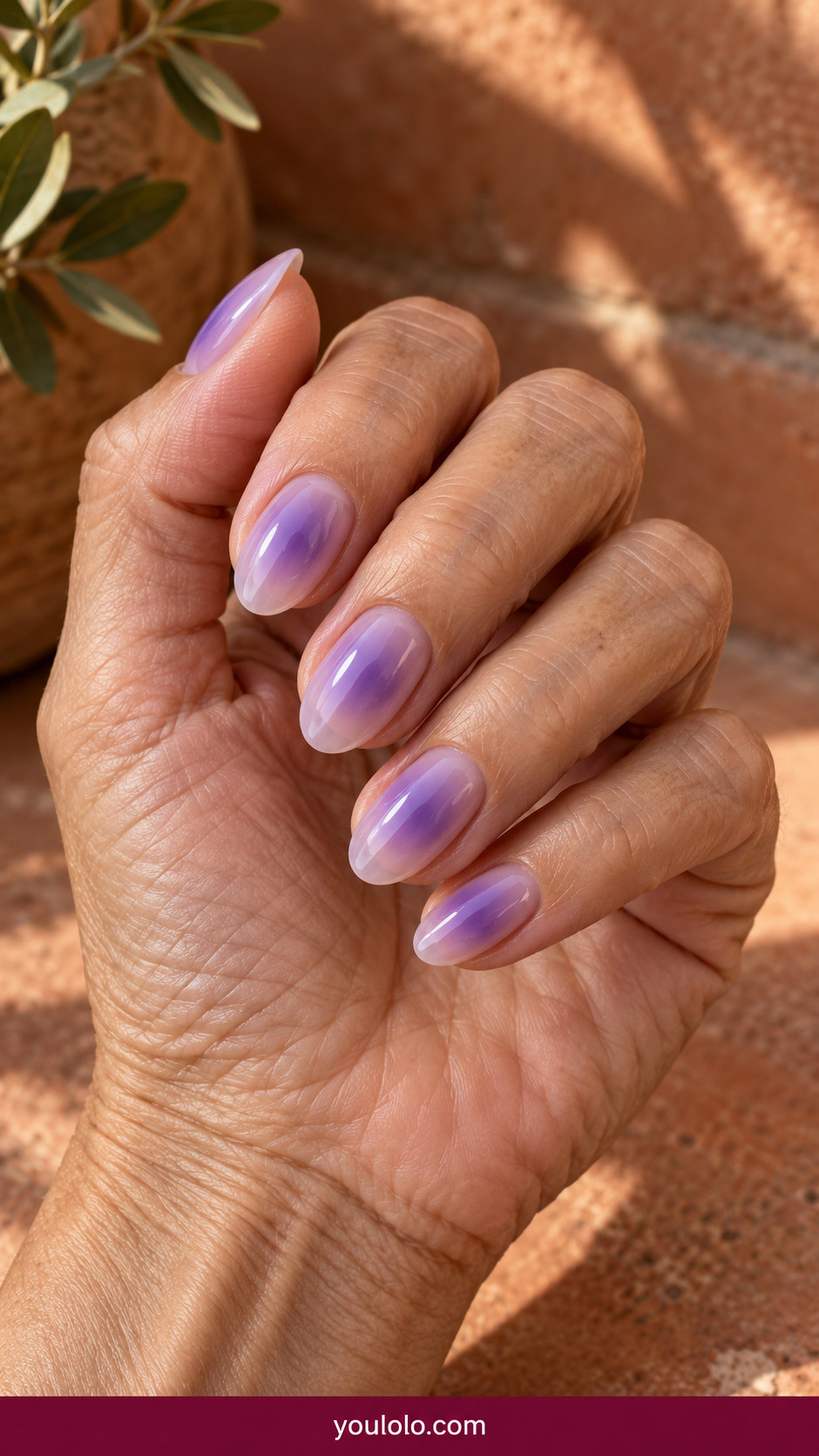 Aura Nails idea 3: lavender nails with hazy violet aura centers and transparent outer edges on an anatomically realistic feminine hand