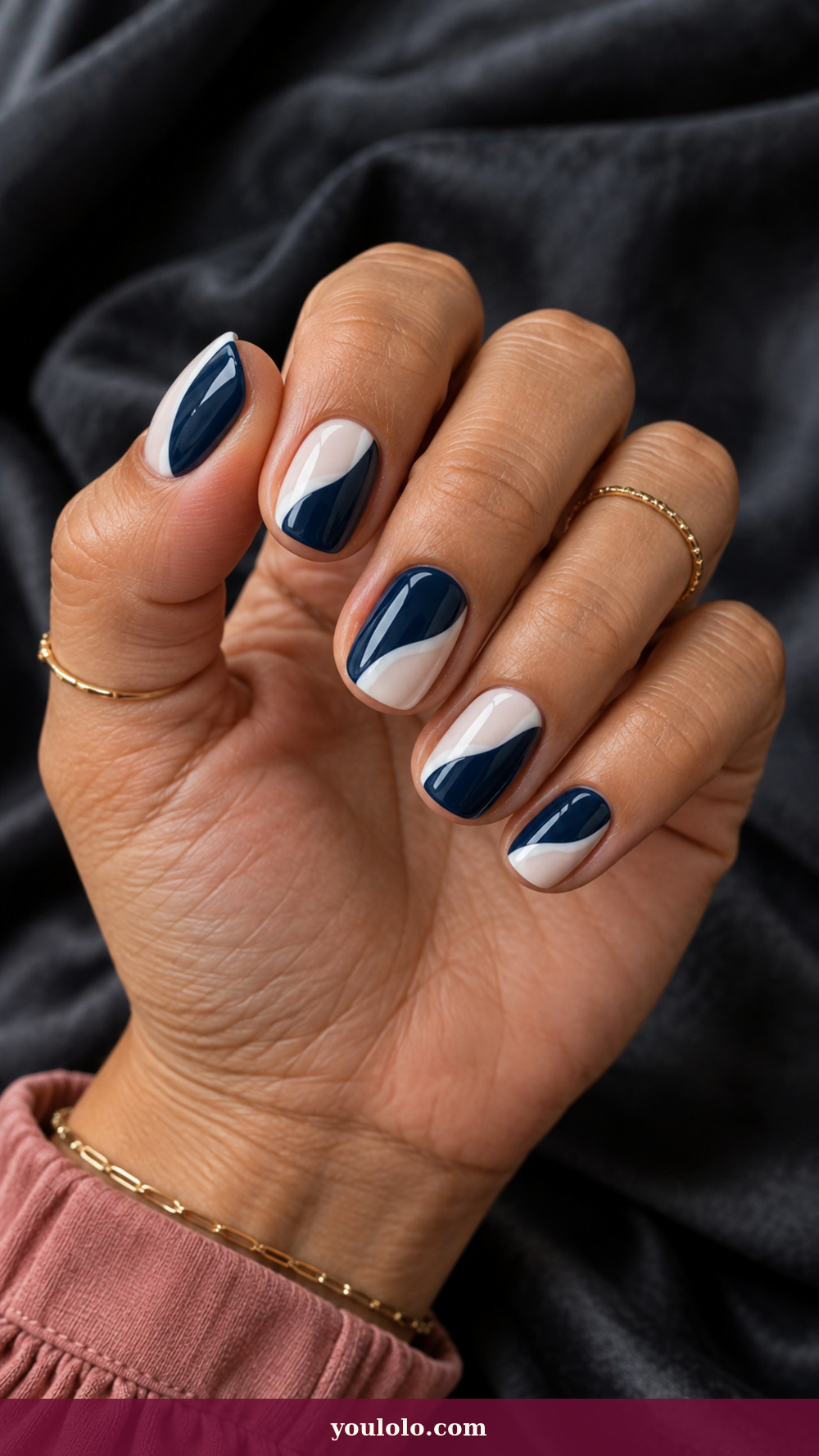Blue and White Nails idea 3: Navy Cut-Paper Waves on a realistic feminine hand
