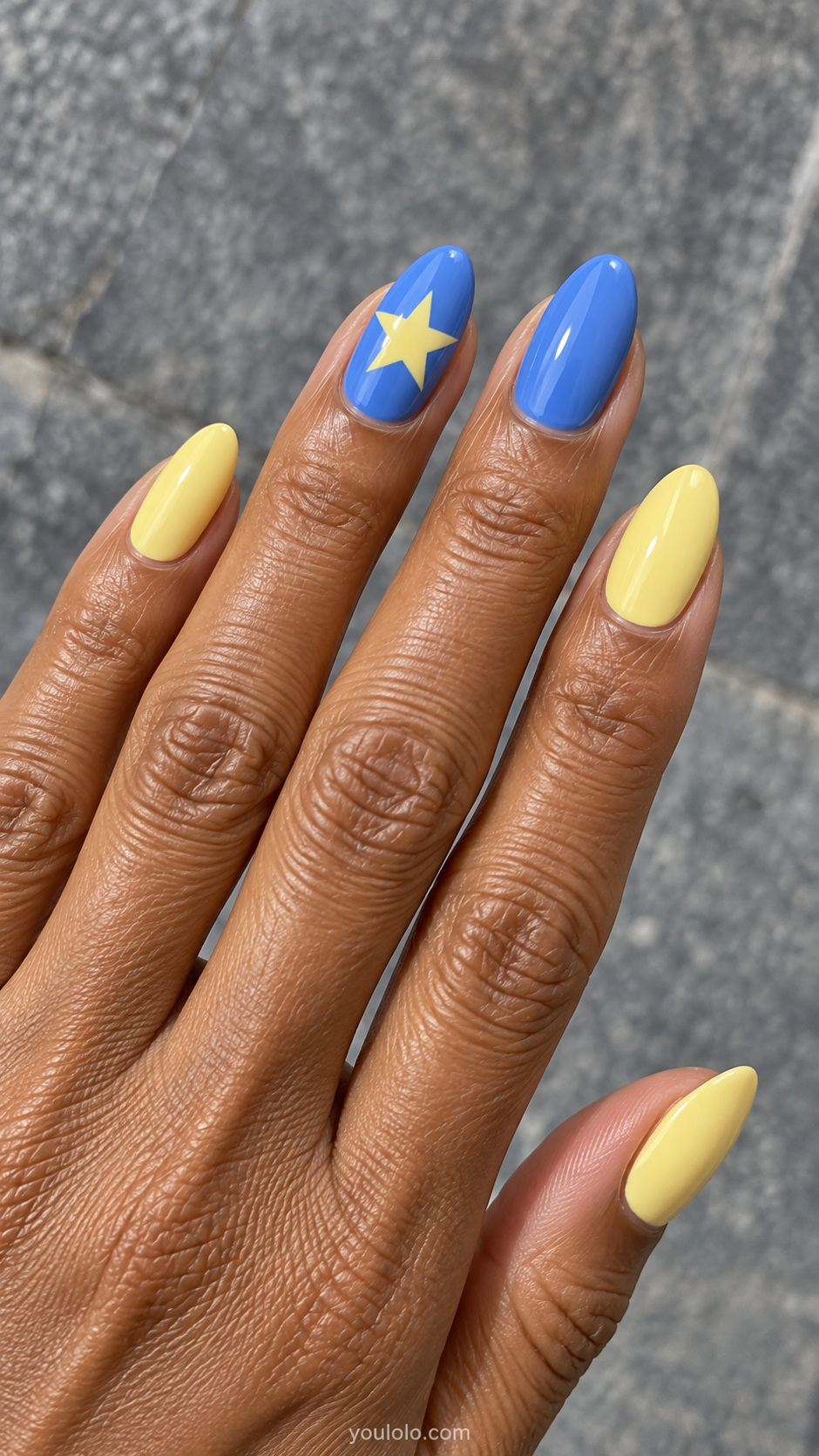 Butter yellow nails — one yellow star on a blue nail