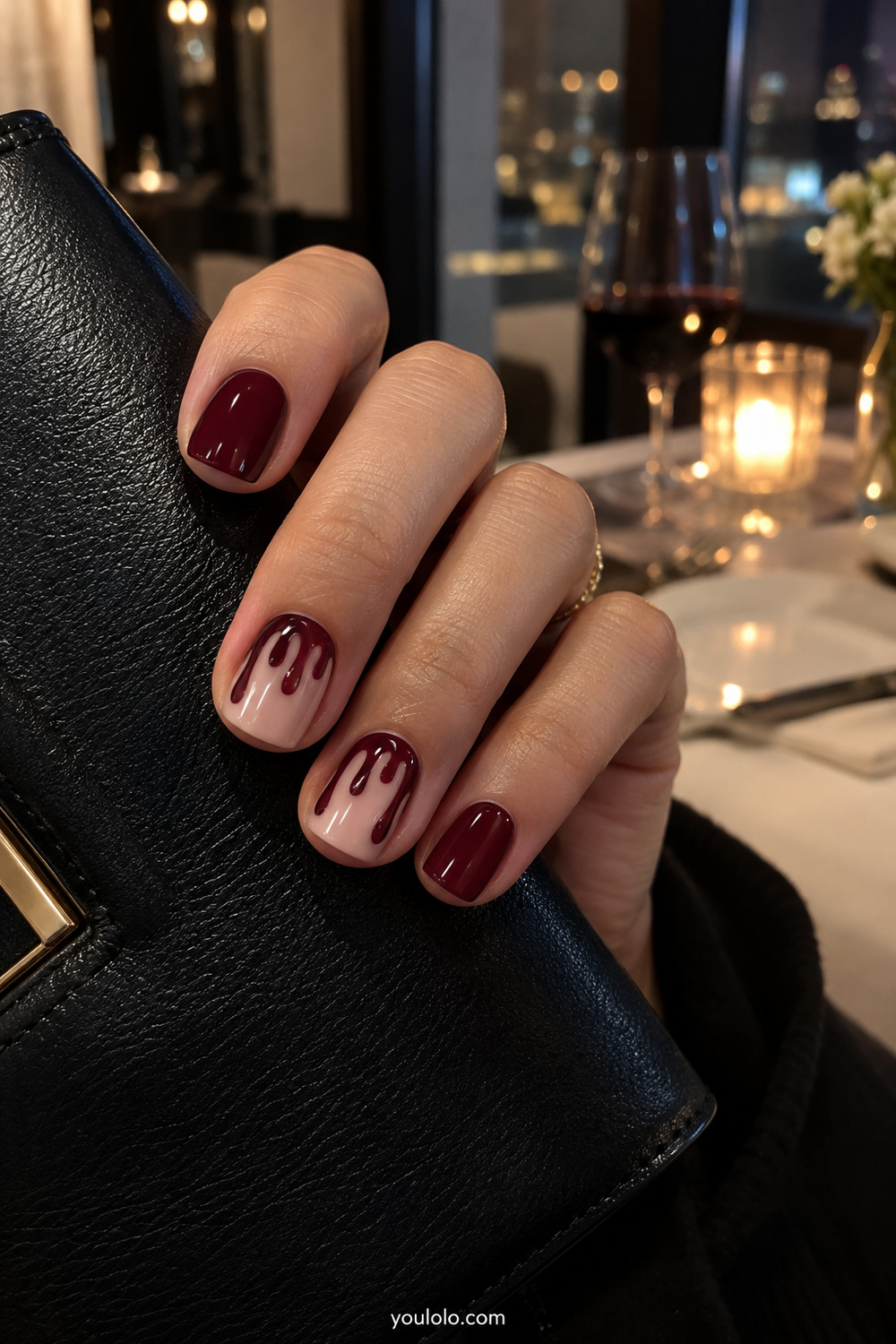 Glossy oxblood manicure with controlled dark red drip accents