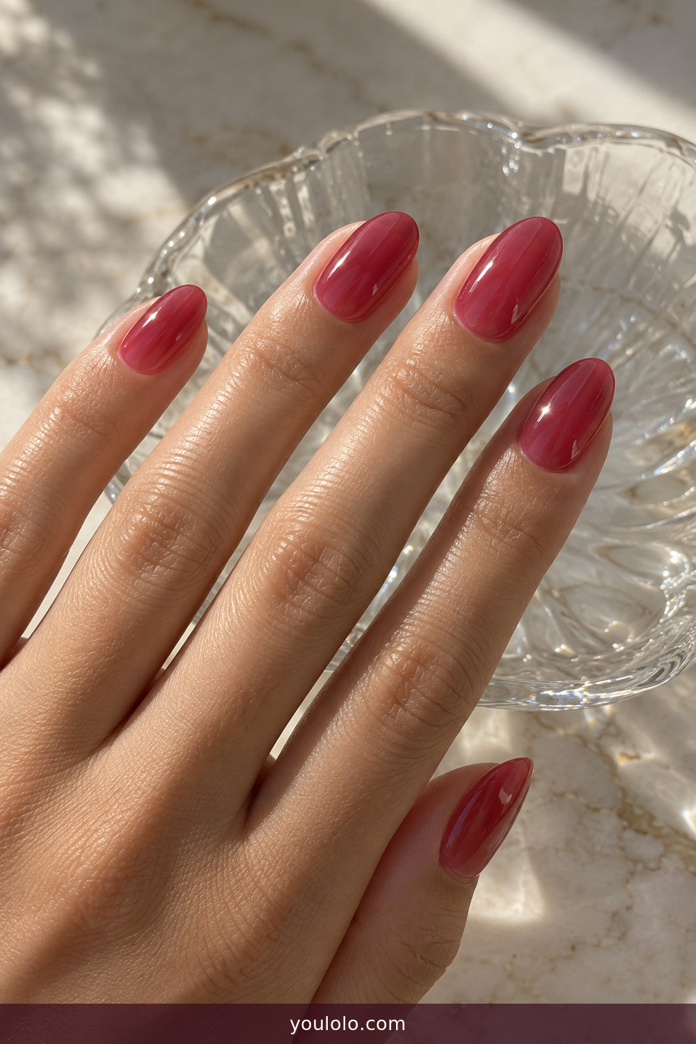 Translucent raspberry jelly nails in natural sunlight