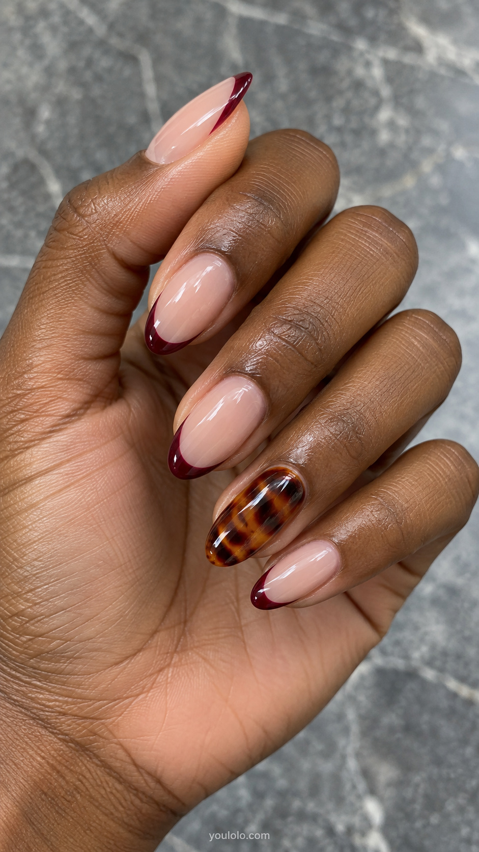 Burgundy French tips and one full tortoiseshell nail manicure