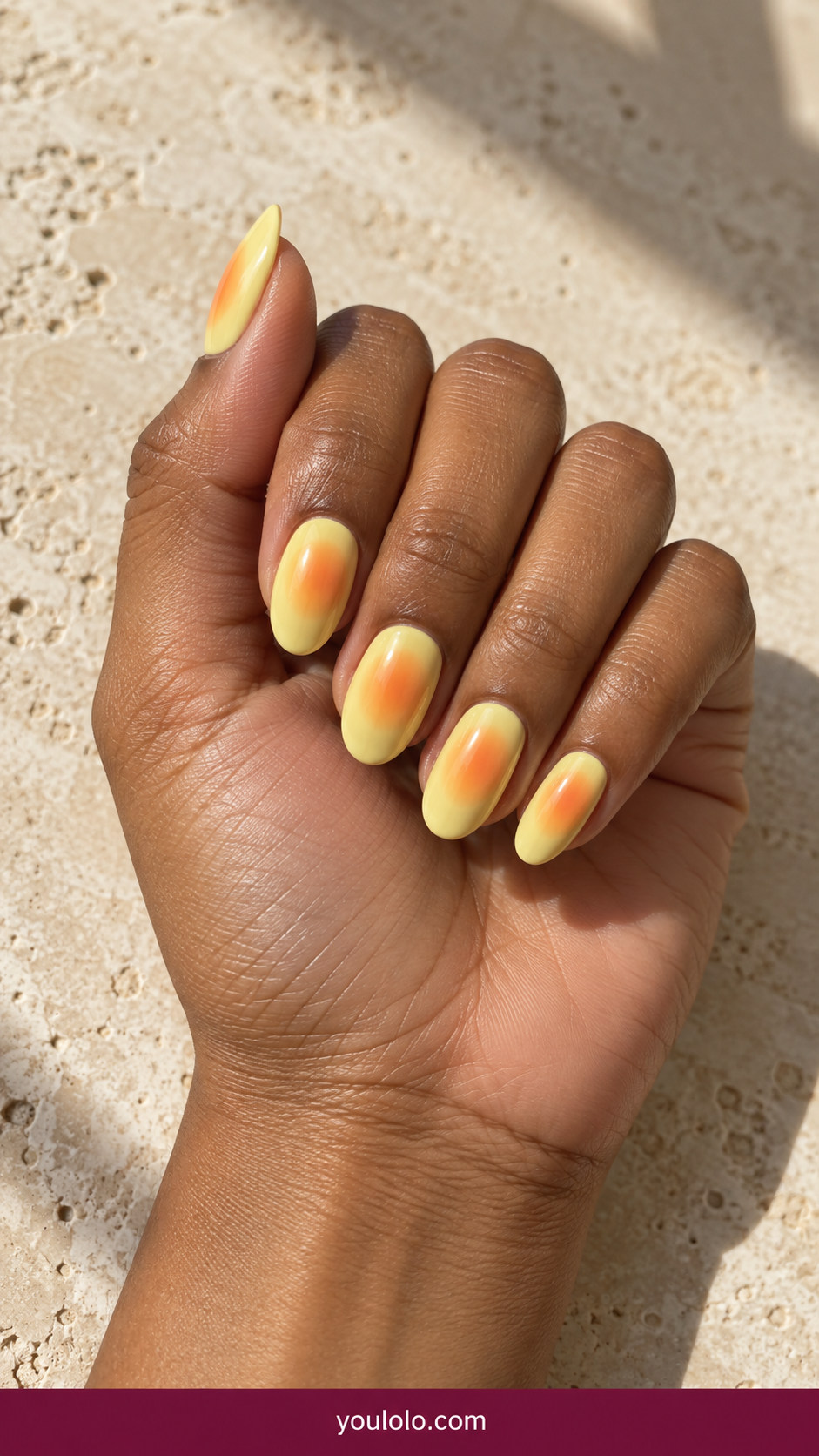 Aura Nails idea 4: butter-yellow nails with warm orange diffused center on an anatomically realistic feminine hand
