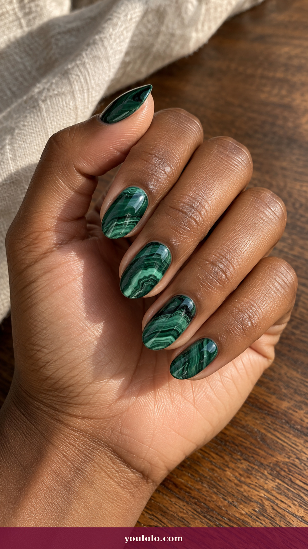 Short Stiletto Nails idea 4: Malachite Slice on a realistic feminine hand