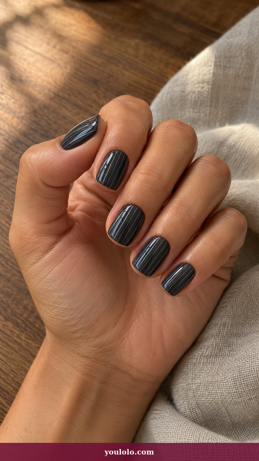 Italy Nails idea 4: Milan Charcoal Pinstripe on a realistic feminine hand
