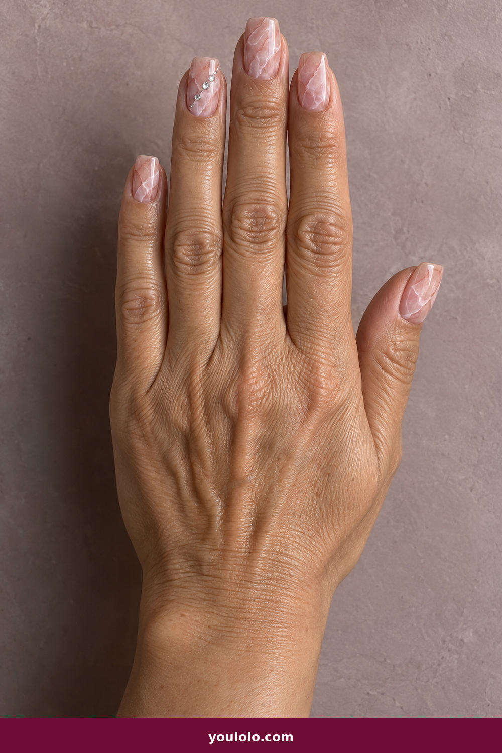 Pink Nails with Rhinestones on One Finger Ideas: Rose Quartz Veins and Gems, Rose-quartz soft-square nails with milky mineral veins and three tiny crystals following one vein on the index finger.