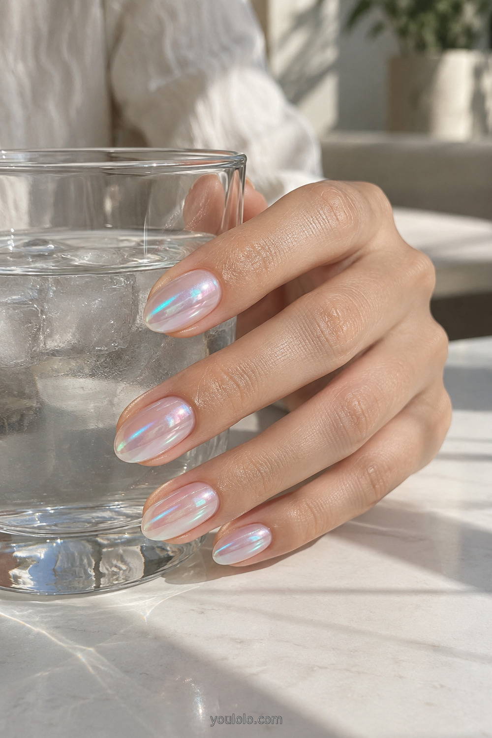 Aqua and pink aurora chrome manicure on short almond nails