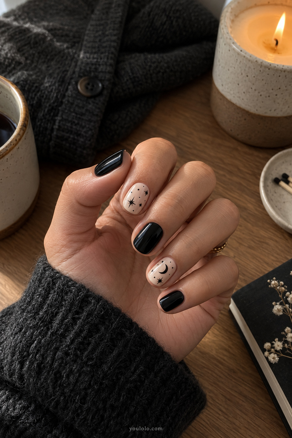 Black and cream celestial short nails with stars and a crescent