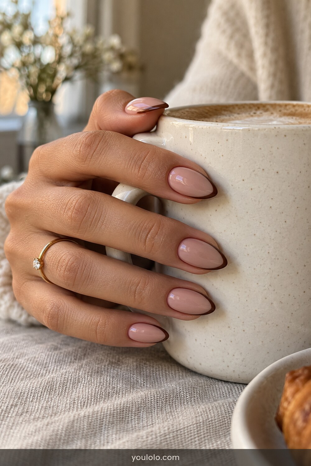 Sheer almond nails with a fine cocoa outline