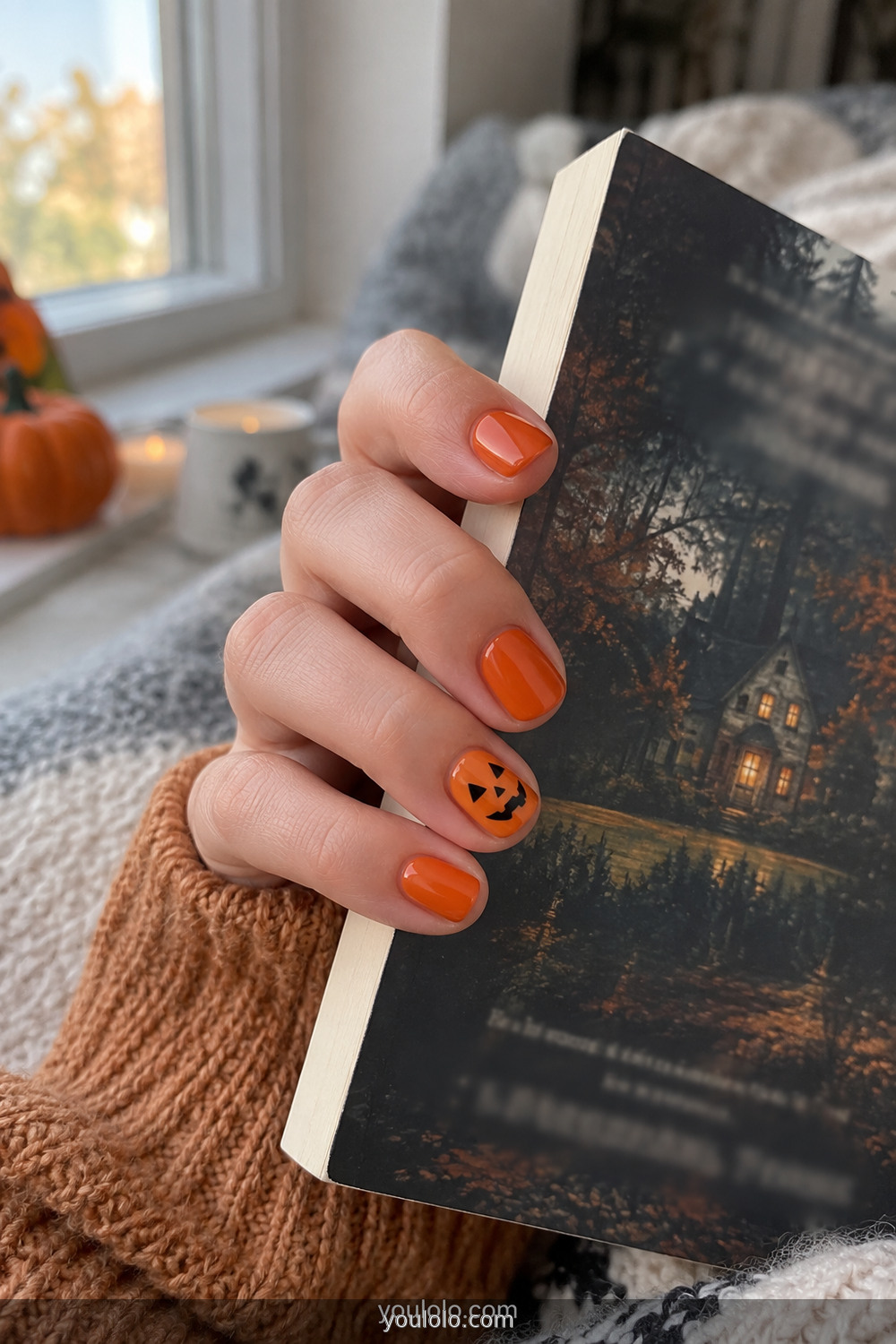 Pumpkin orange nails with one simple jack o lantern face