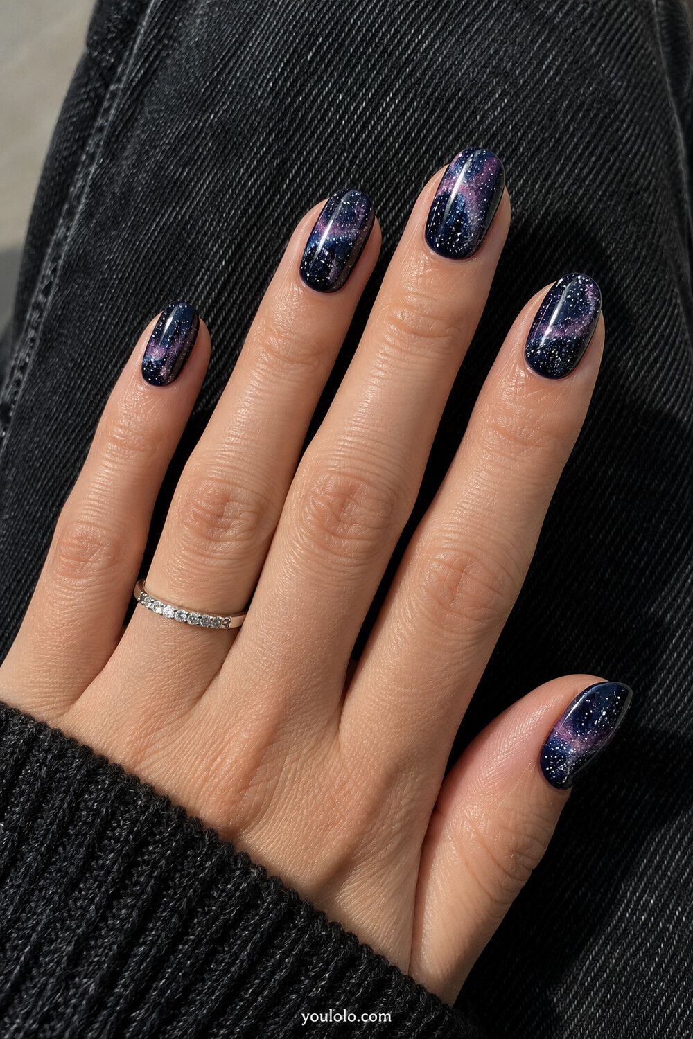 Midnight navy manicure with a realistic purple pink sponged nebula