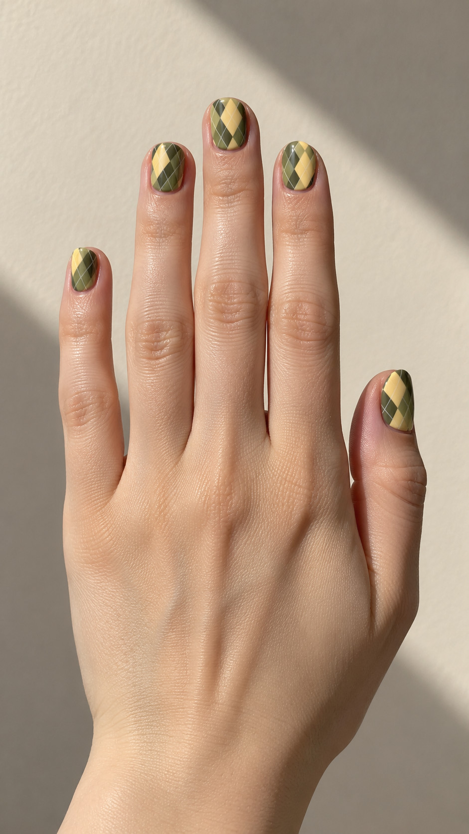 Plaid Nails idea 5: Olive Argyle Angles manicure on a realistic feminine hand