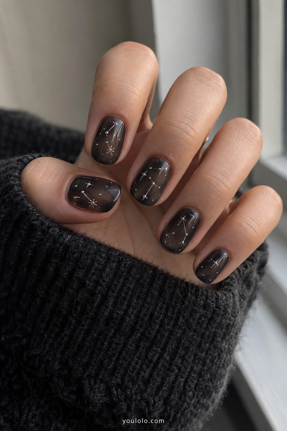 Short translucent black jelly nails with silver constellation line art