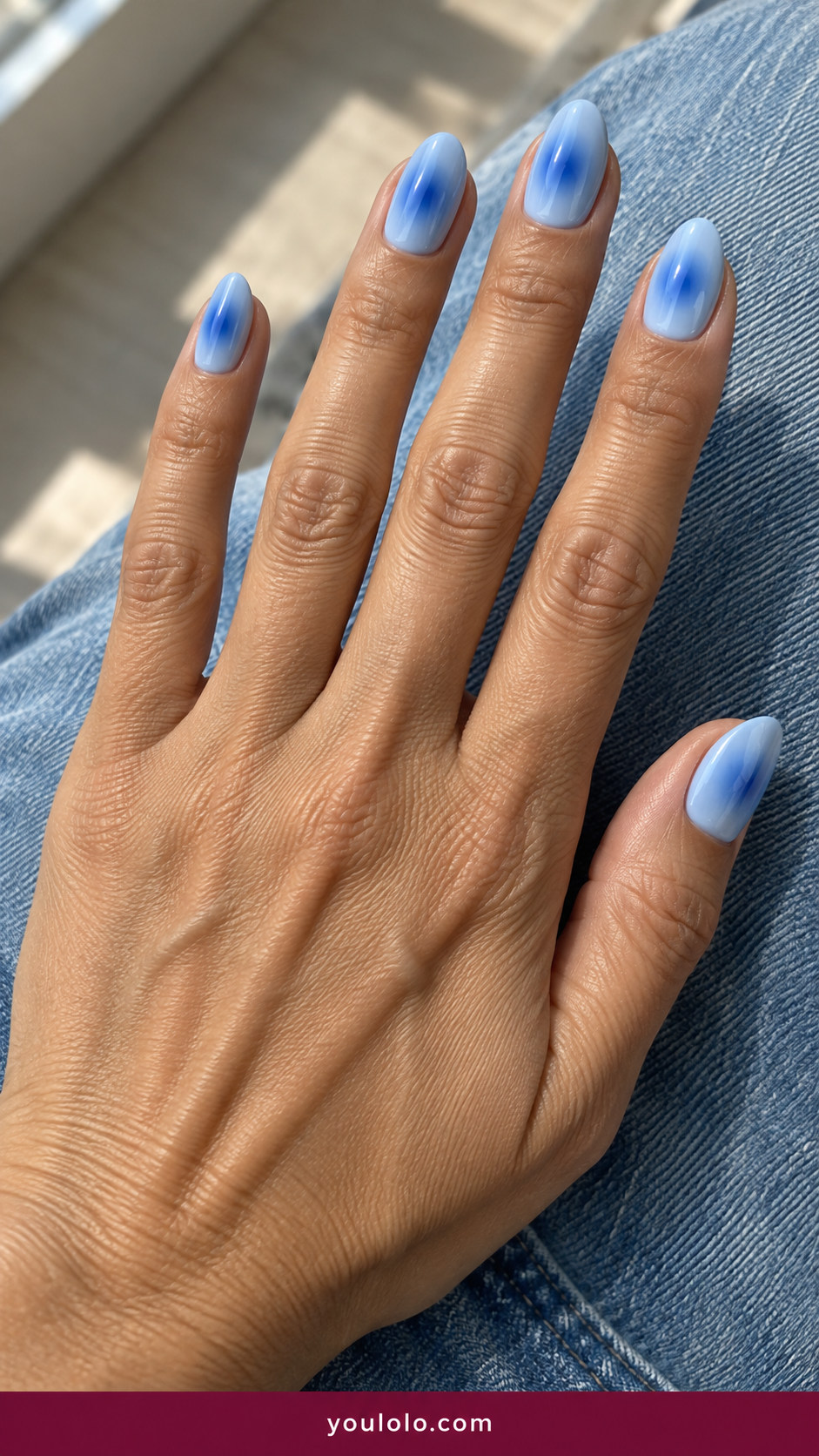 Aura Nails idea 6: pale blue nails with cool cobalt hazy center glow on an anatomically realistic feminine hand