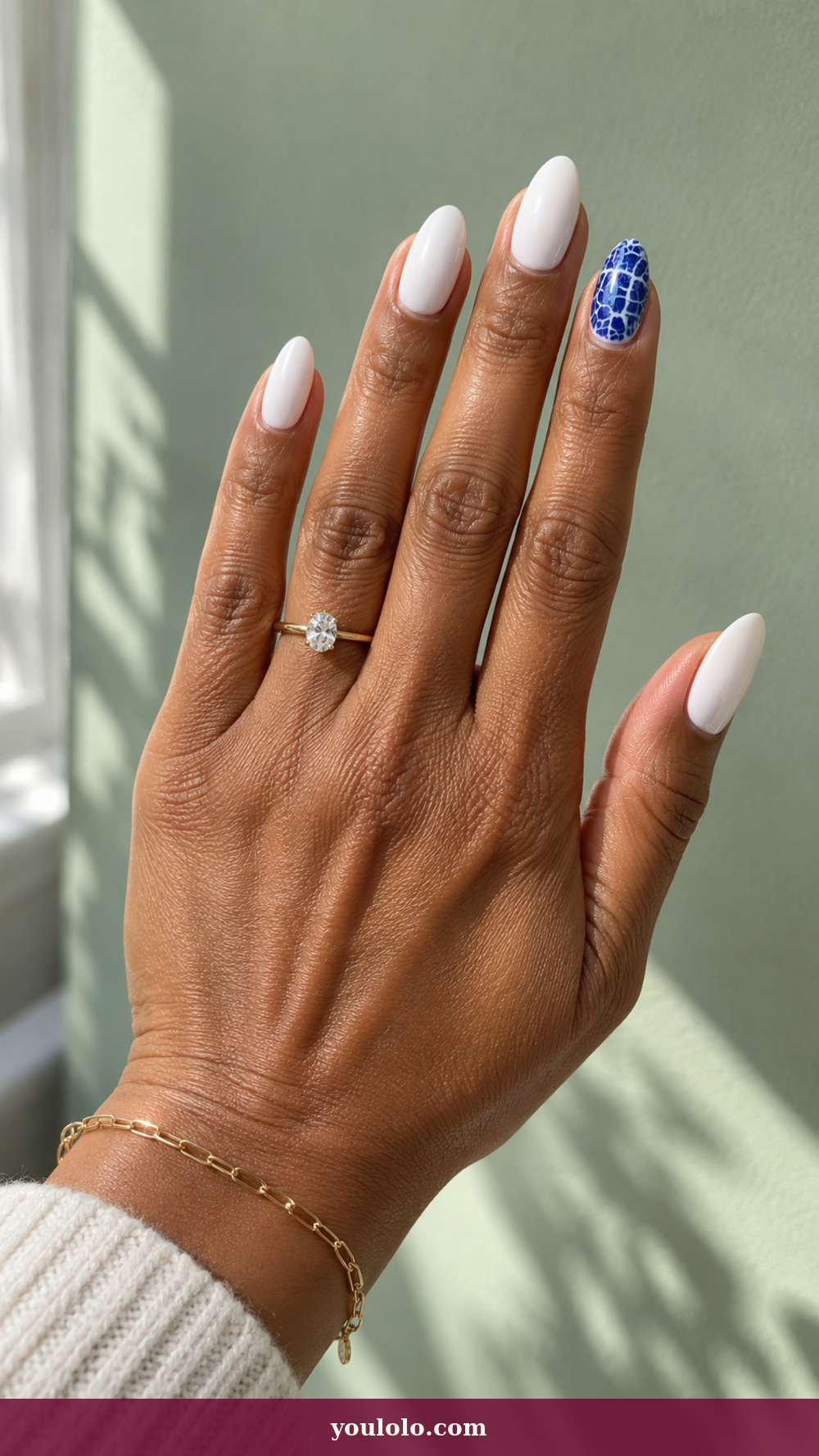 Blue and White Nails idea 6: Porcelain Crackle Accent on a realistic feminine hand