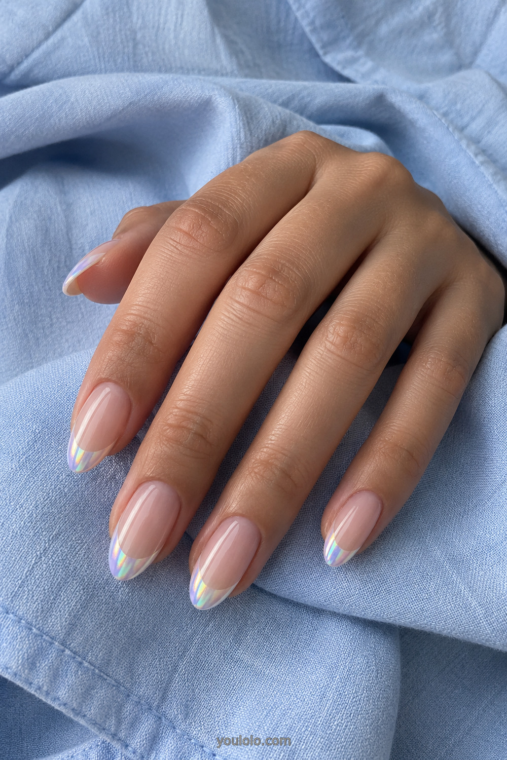 Nude almond nails with thin iridescent unicorn French tips
