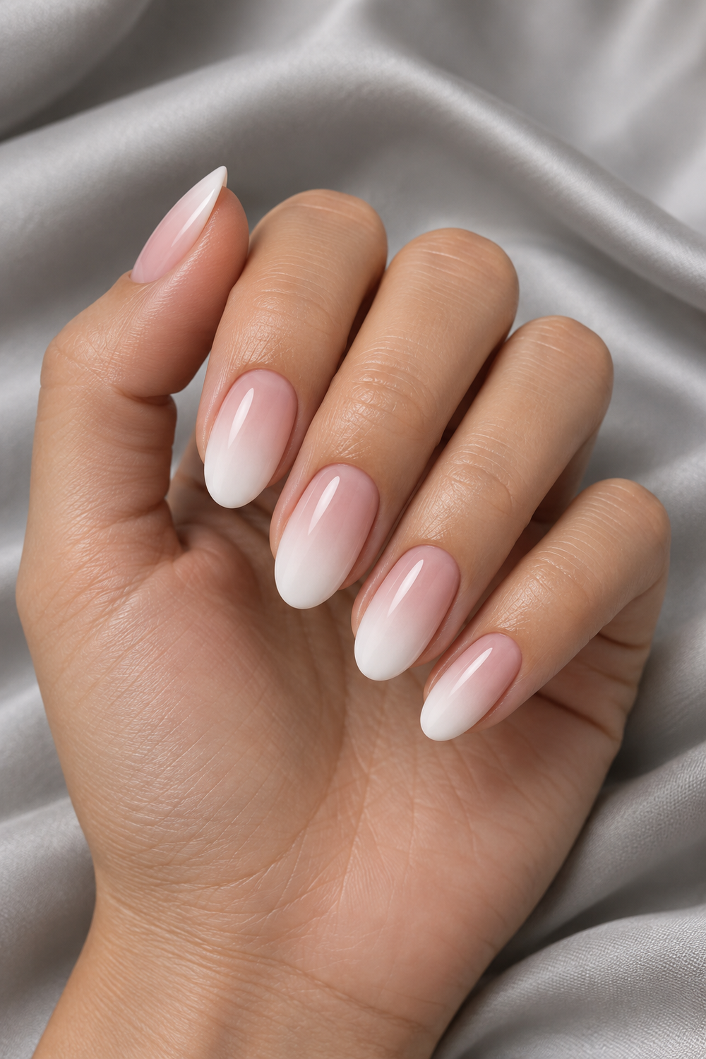 Baby boomer ombre French nails with a seamless pink to white fade