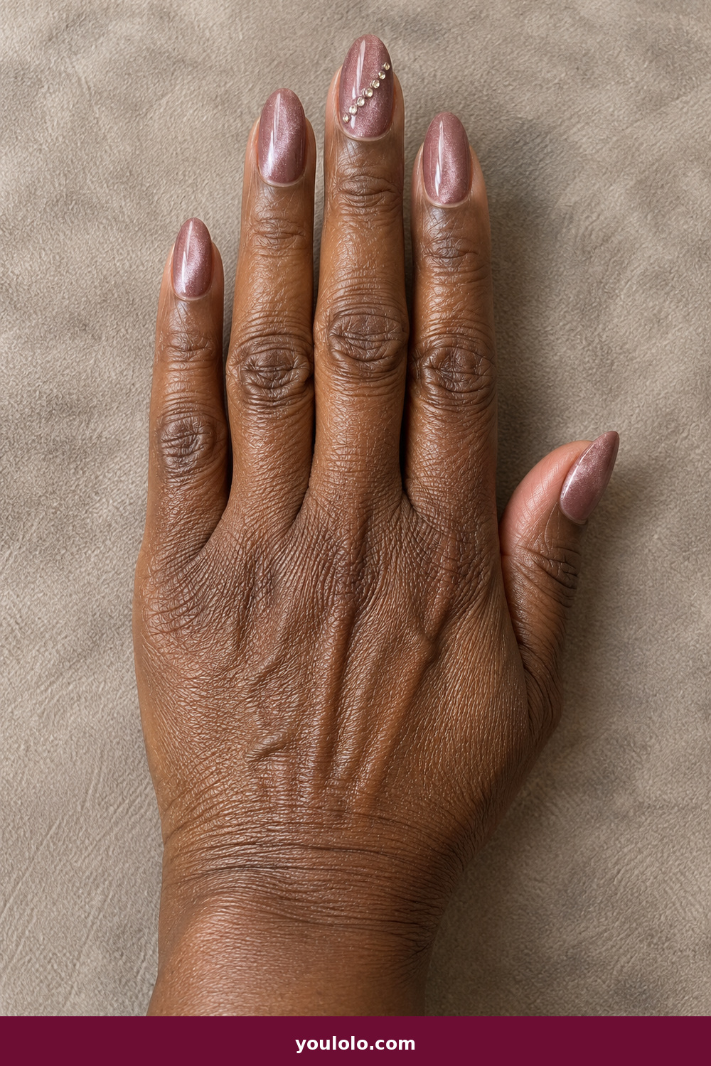 Pink Nails with Rhinestones on One Finger Ideas: Dusty Rose Velvet Diagonal, Muted dusty-rose almond velvet nails with a slim diagonal trail of champagne crystals on the middle finger.