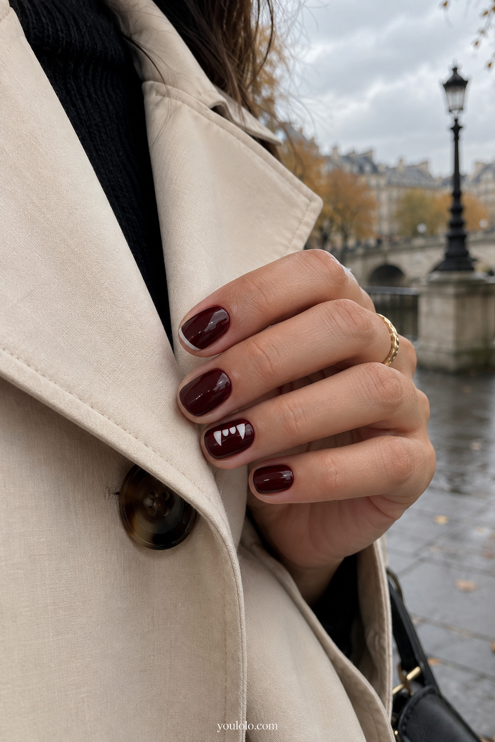 Black cherry short nails with a tiny vampire fang accent