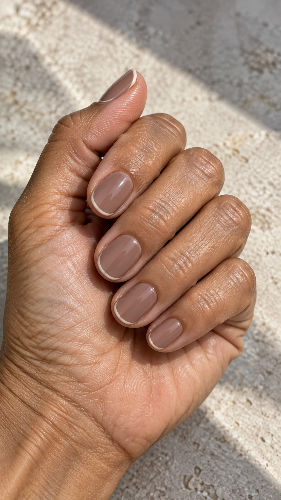 Italian Manicure idea 7: Warm Taupe Borders manicure on a realistic feminine hand