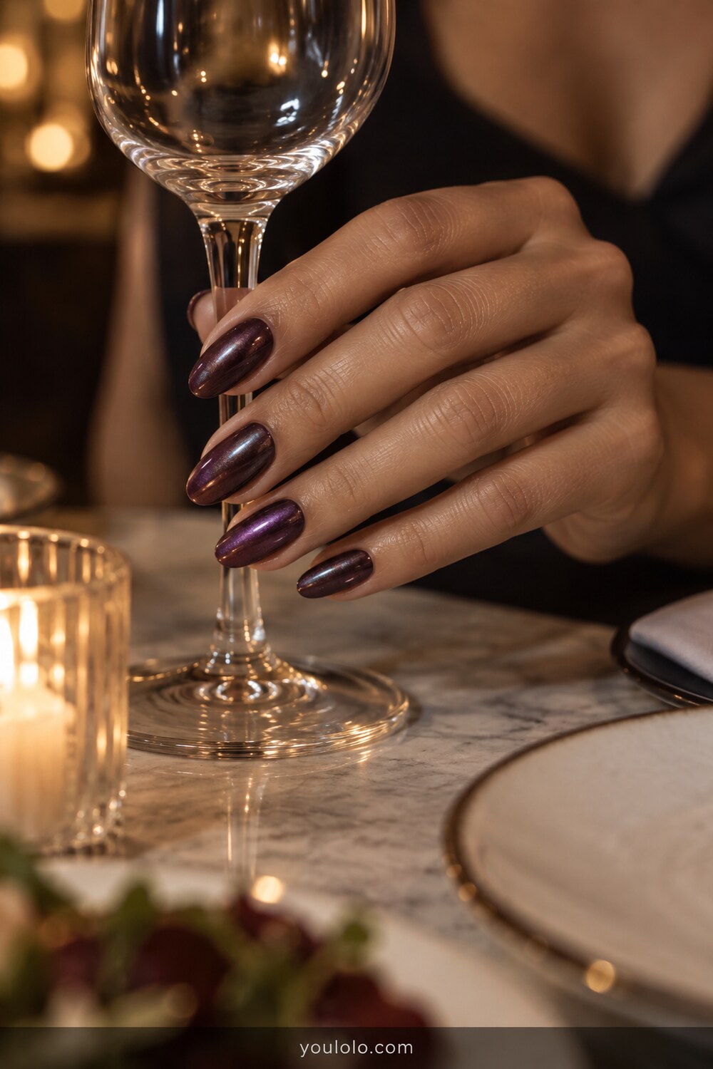 Aubergine almond nails with a fine pearl chrome finish
