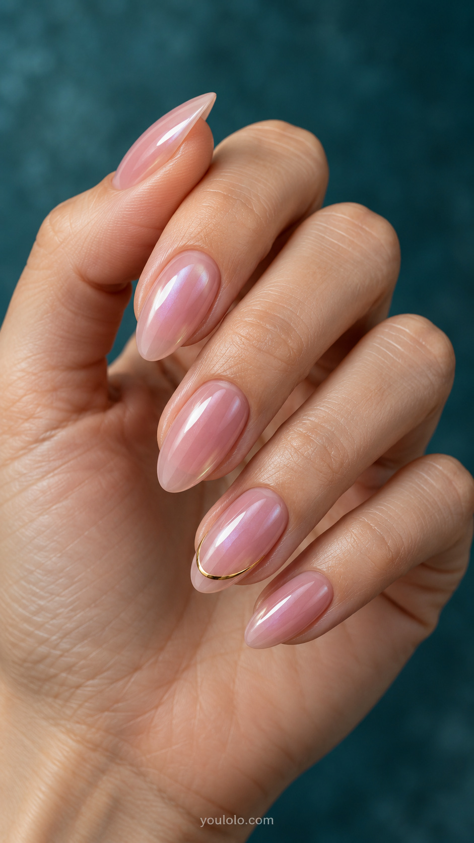 Glazed pink with one fine metallic arc manicure