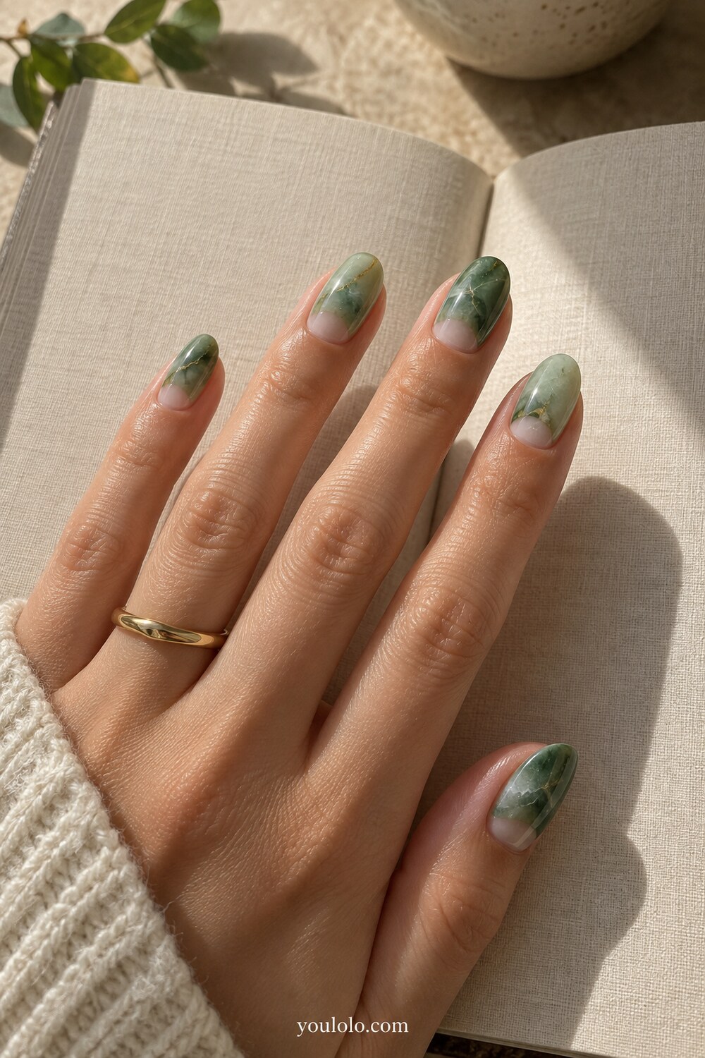 Soft sage green manicure with subtle stone texture