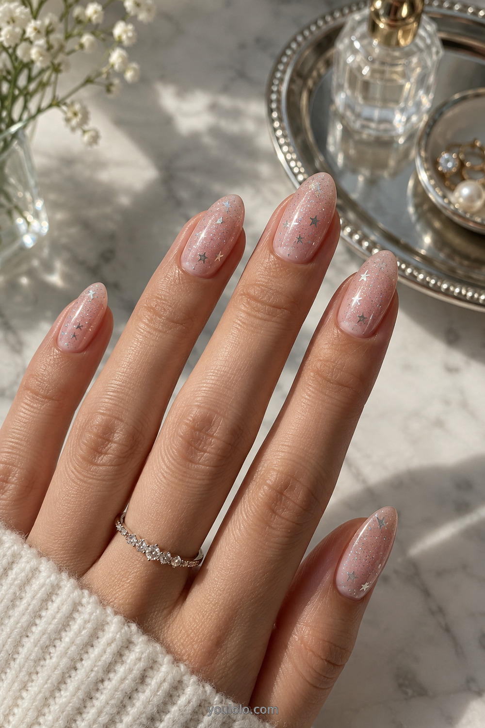 Sheer blush manicure with tiny holographic star details