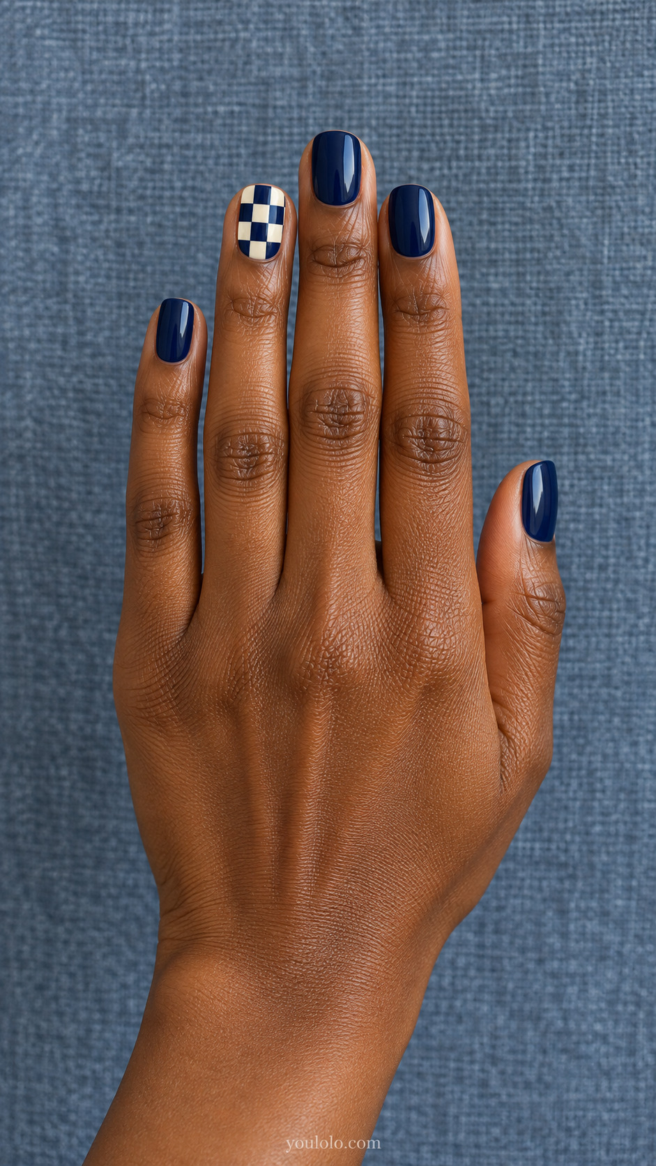 Cream and Navy Checker Accent — Short squoval nails; one ring nail with large cream/navy checkerboard, solid navy remaining nails.