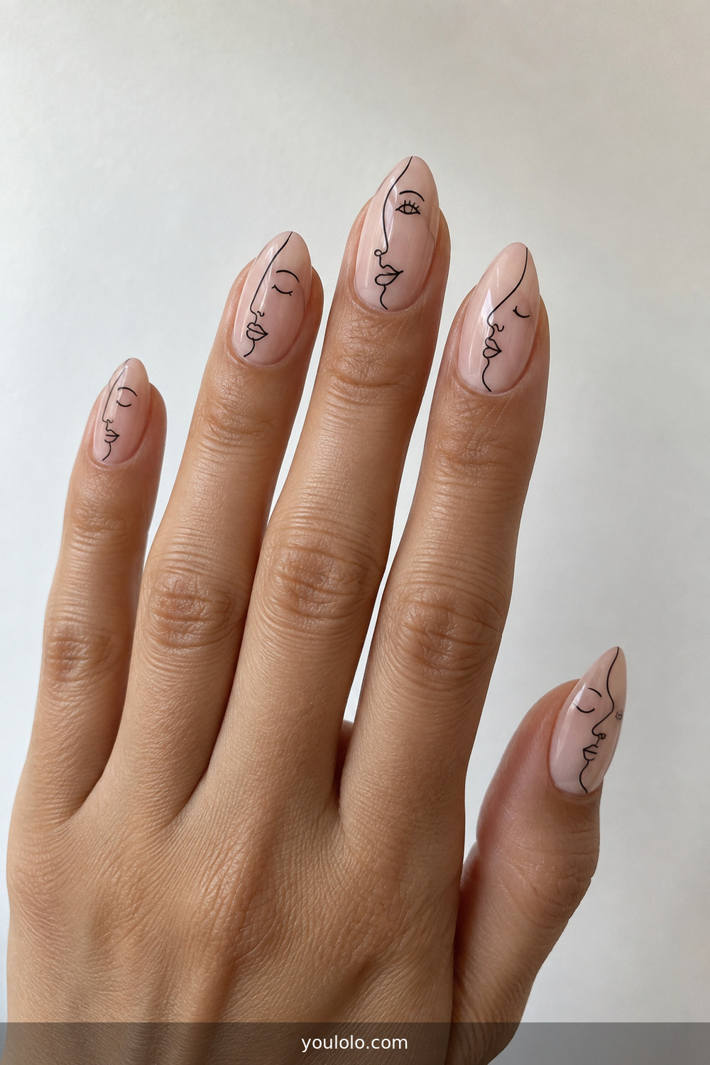 Sheer nude nails with delicate black line-art faces