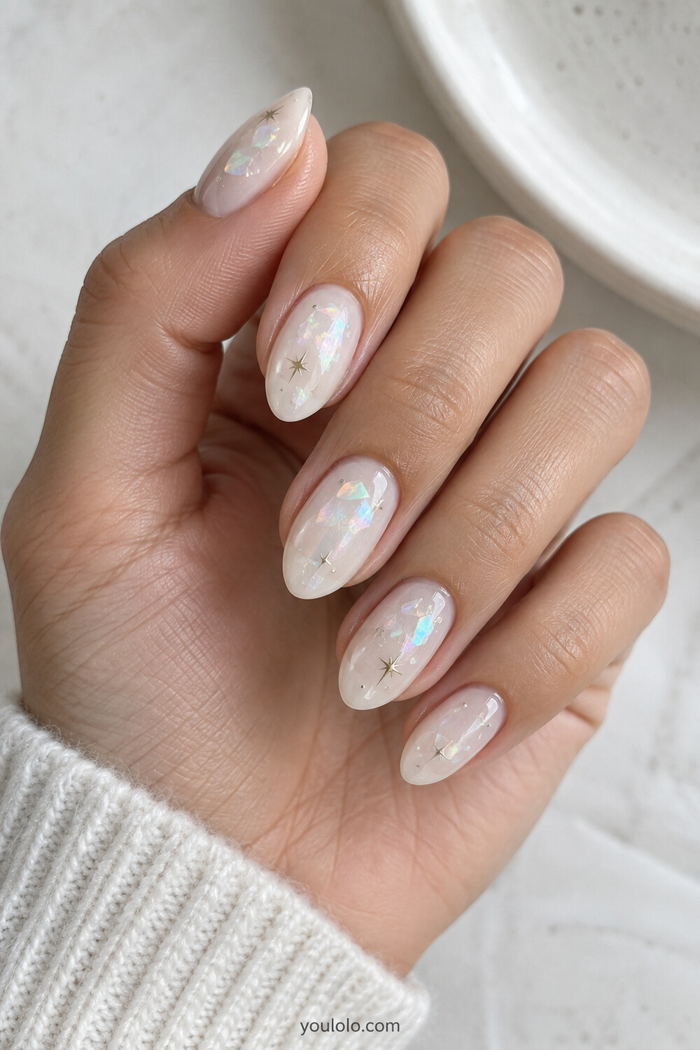 Milky white nails with subtle opal foil and tiny celestial accents