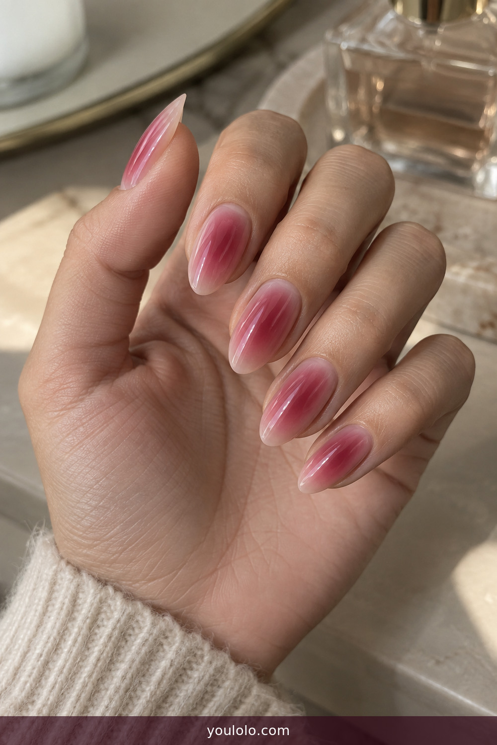 Soft raspberry aura design on almond nails