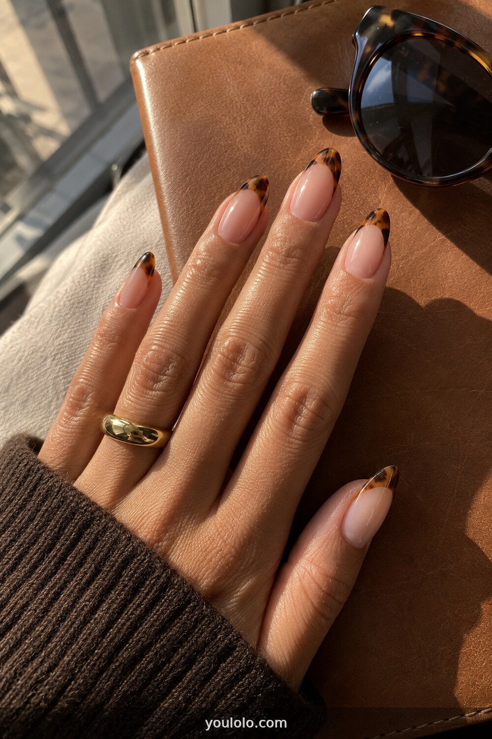 Soft tortoiseshell French tips on almond nails