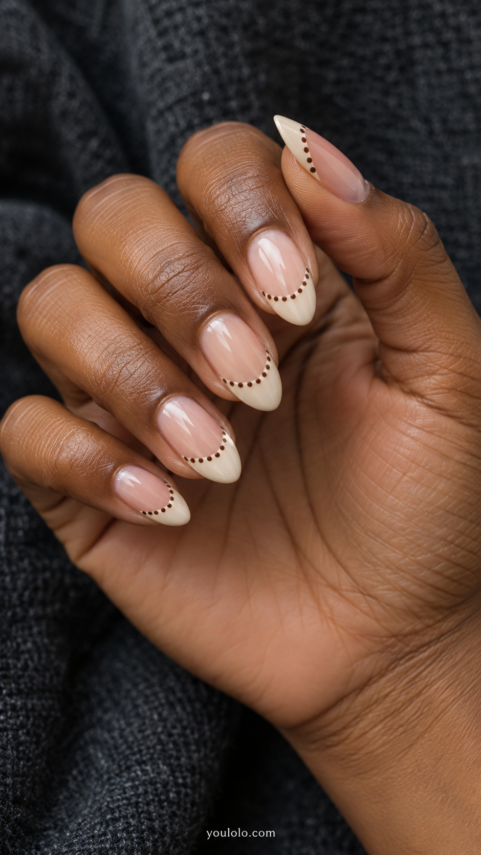 Brown dots along a curved French line manicure