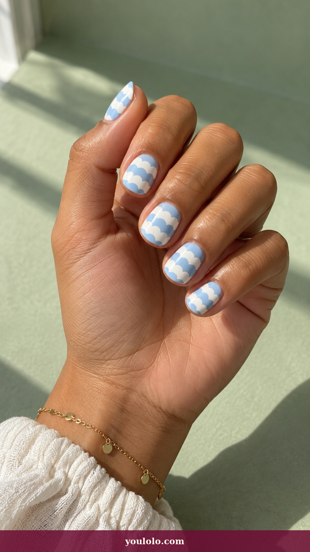 Blue and White Nails idea 10: Cloud Blue Scallop Rows on a realistic feminine hand