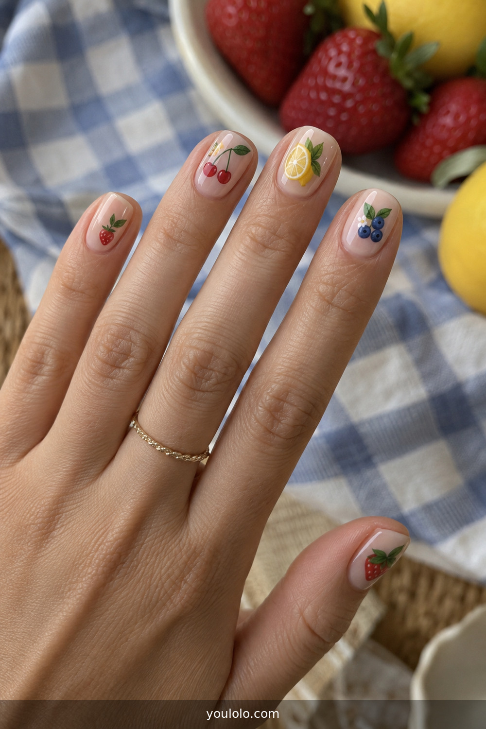 Mismatched miniature fruit nail art on short natural nails