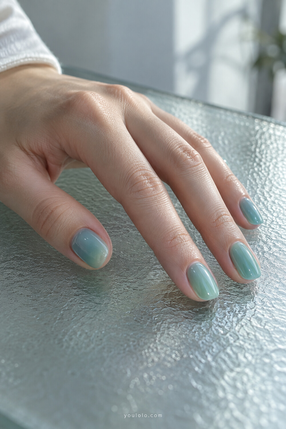 Sheer aqua sea glass jelly manicure on short natural nails