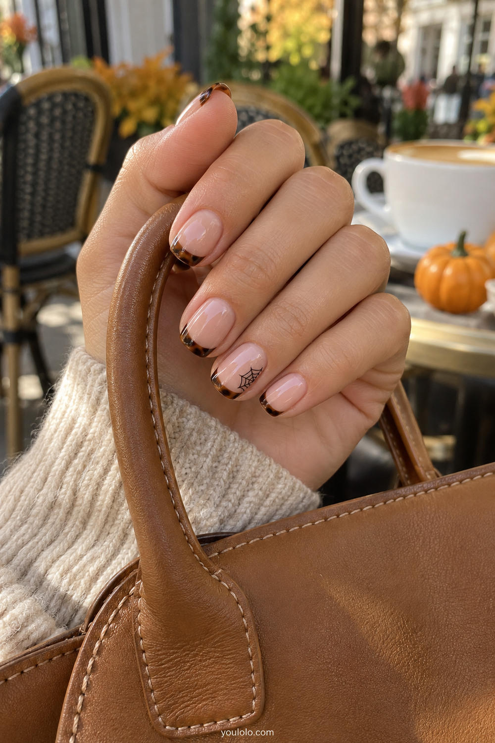 Tortoiseshell French tips with a miniature black web accent