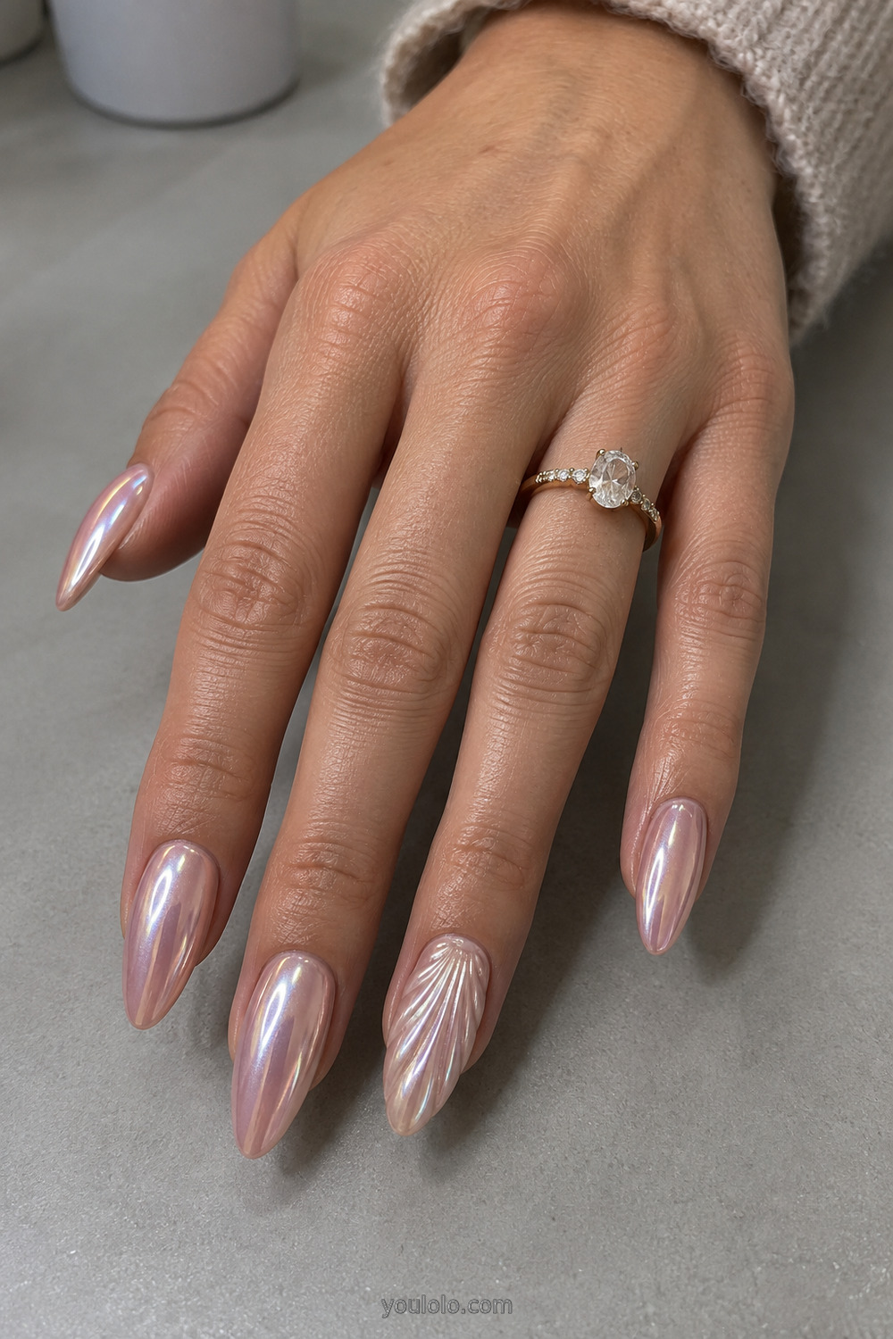 Pearl chrome almond nails with one sculpted shell ridge accent