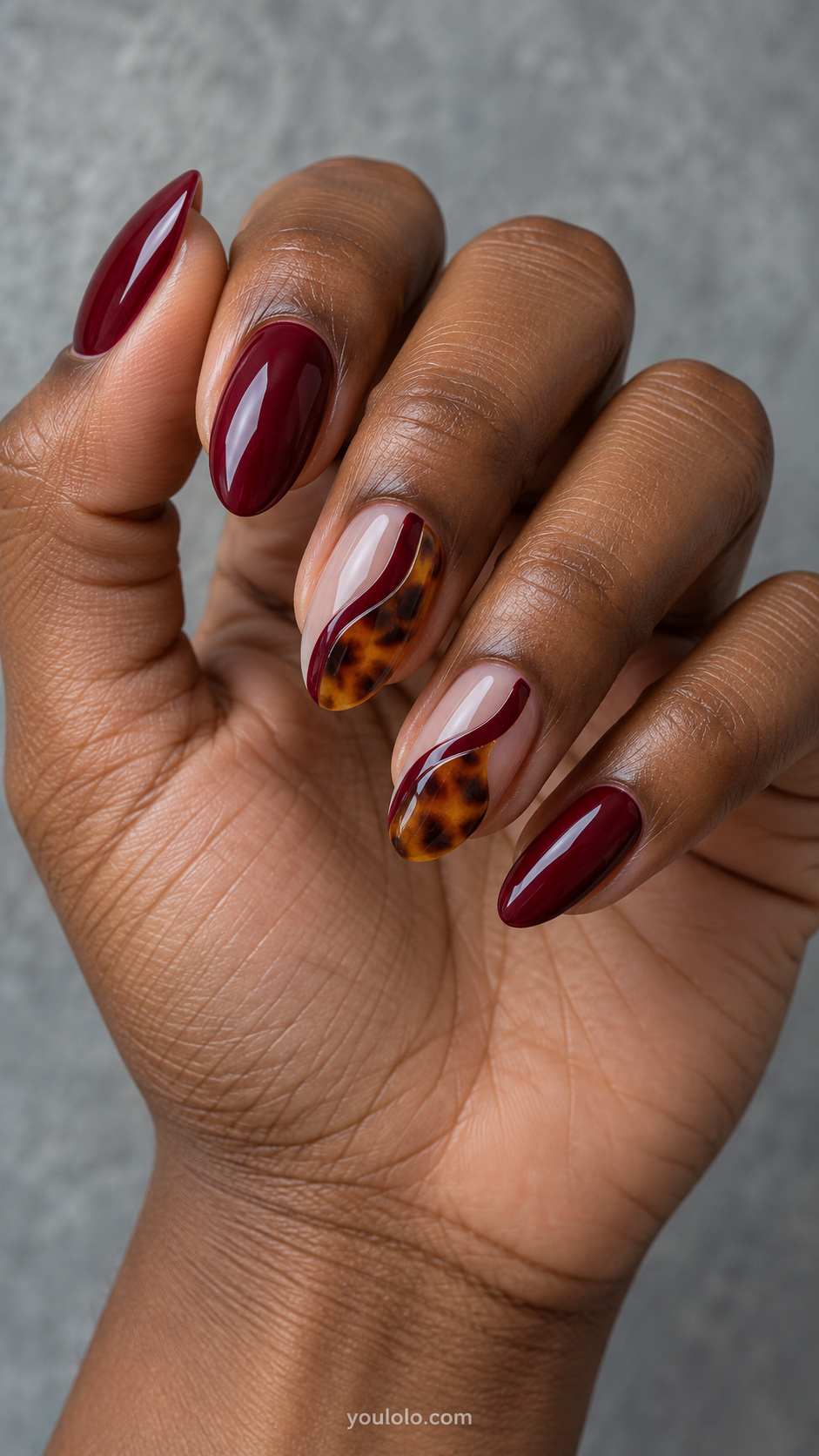 Burgundy waves beside amber windows manicure